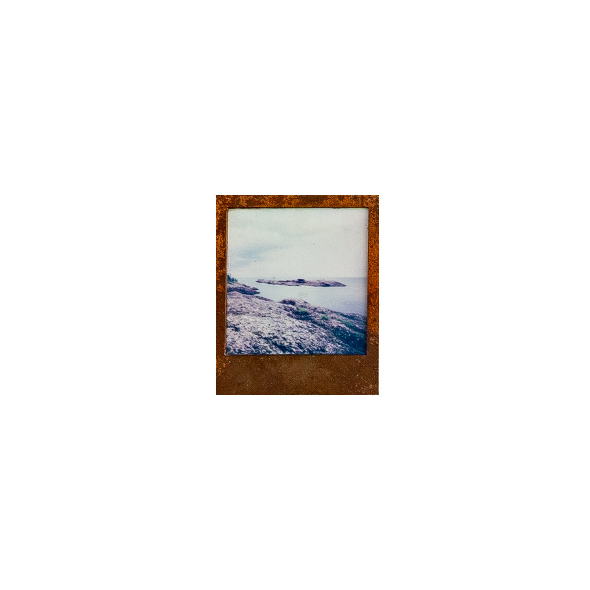 Steel Framed insant film photograph of a coastal scene in the keeweenaw peninsula  on a white background